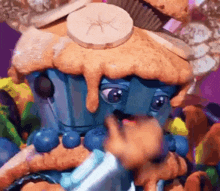 a blue cupcake with a banana on top of it .
