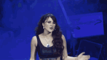 a woman with red hair and a black top is dancing