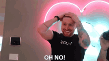 a man wearing a black shirt that says " oh no "