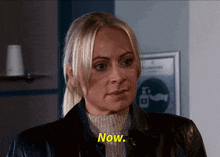 a woman in a leather jacket says now