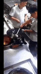a man in a chef 's uniform is stirring food in a frying pan