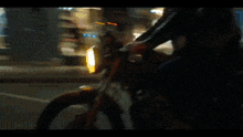 a person is riding a bike in front of a store .