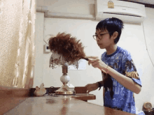 Thai Kid Cleaning With A Nest Hair Lol GIF