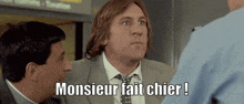 a man in a suit and tie is talking to a police officer and says monsieur fait chier