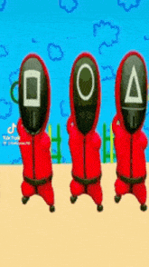 three squid game characters are standing next to each other .