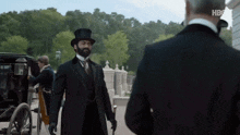 a man in a top hat is standing next to another man