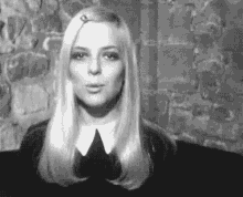 a woman with long blonde hair is wearing a black and white photo