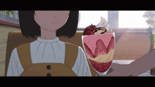 a person holding a glass of strawberry dessert