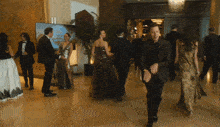 a group of people are walking down a hallway with a sign that says ' hollywood ' on it