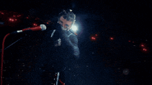 a blurry image of a person in a dark room with a light behind them
