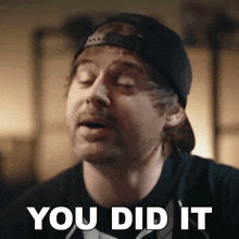 a man wearing a black hat and a black shirt says you did it