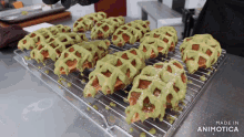 a bunch of waffles are sitting on a cooling rack made by animatica