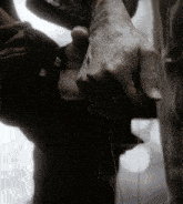 a close up of a person 's hand holding strings