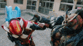 a man in a red helmet is fighting another man with horns