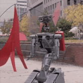 a robot is walking in front of a red umbrella