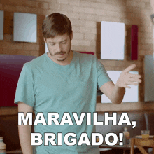 a man in a blue shirt is standing in front of a sign that says maravilha brigado