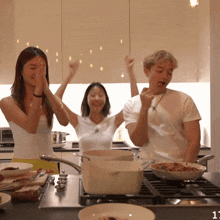 a man and two women are cooking in a kitchen with the number 11 on the counter