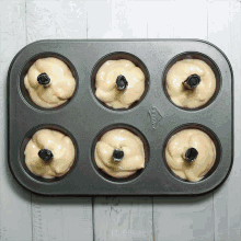 a muffin pan with six doughnuts in it has a label that says " carry " on it