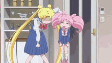 a girl with pink hair is standing next to a girl with yellow hair