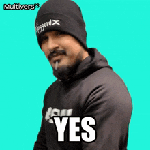 a man with a beard wearing a beanie and a hoodie that says yes