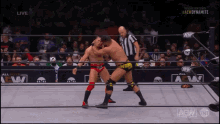 two men are wrestling in a ring that says aew dynamite