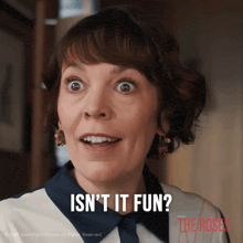 a woman says " isn 't it fun " while smiling