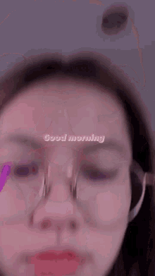 a close up of a woman wearing glasses and headphones .