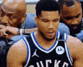 a basketball player wearing a jersey that says bucks