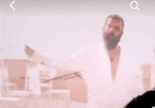 a blurred image of a man with a beard is being searched