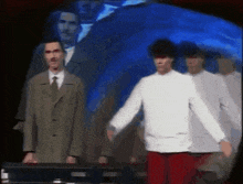 a group of men are standing next to each other on a stage .