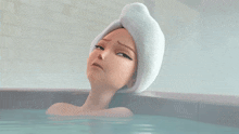 a woman with a towel wrapped around her head is laying in a bathtub