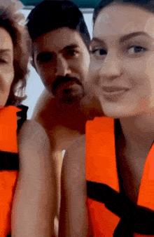 a man and a woman are wearing life vests