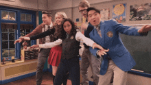a group of people are posing for a picture in a classroom with a poster on the wall that says " be ready " on it