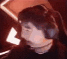 a pixelated image of a person wearing headphones and smiling