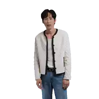 a man wearing a white sweater and blue jeans is standing in front of a white background