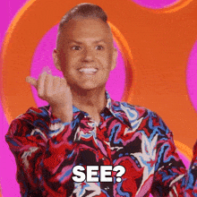 a man in a colorful shirt is making a funny face and says see
