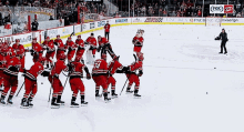 a group of hockey players are on the ice in front of a fox sign