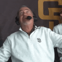 a man wearing a white san diego padres sweater