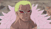 a man with a yellow hair and pink feathers is wearing red sunglasses