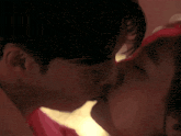 a man and a woman are kissing in a close up