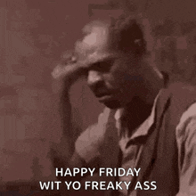 a man in a suit is holding his hand to his head and says happy friday wit yo freaky ass .