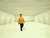 a woman wearing a yellow shirt is smiling and looking at the camera