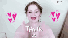 a woman wearing a tiara is giving a thank you sign .