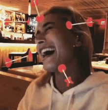a woman is laughing with hearts on her forehead