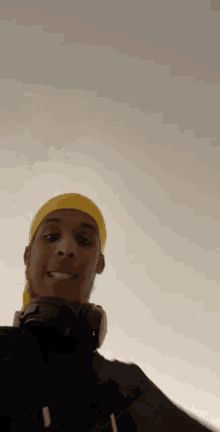 a young man wearing headphones and a yellow headband