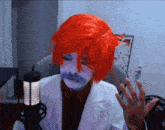 a person wearing a red wig and a white coat sitting in front of a microphone