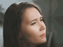 a close up of a woman 's face with a serious look on her face .