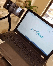a laptop is open to a page that says onlyfans on it