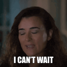 a woman is saying i can 't wait while smiling .