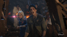 a man and a woman in a scene from a disney + movie